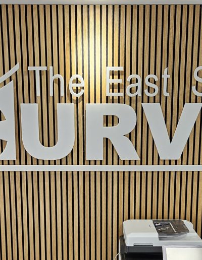 East Cowes Town Council logo displayed on a wooden panel at The East Side Curve